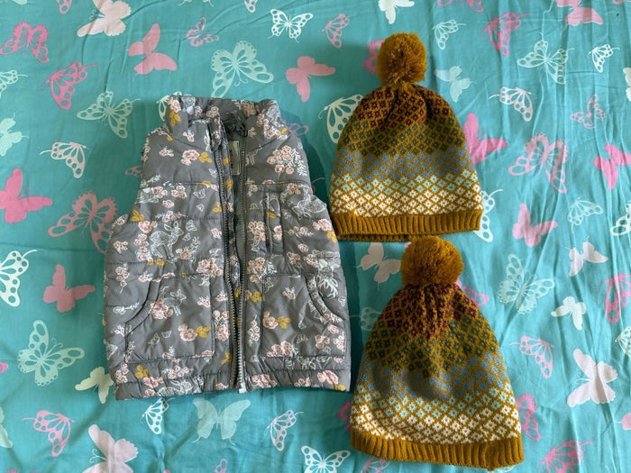 Floral-patterned pouches and a yellow textured bag on a blue fabric background with butterfly designs.